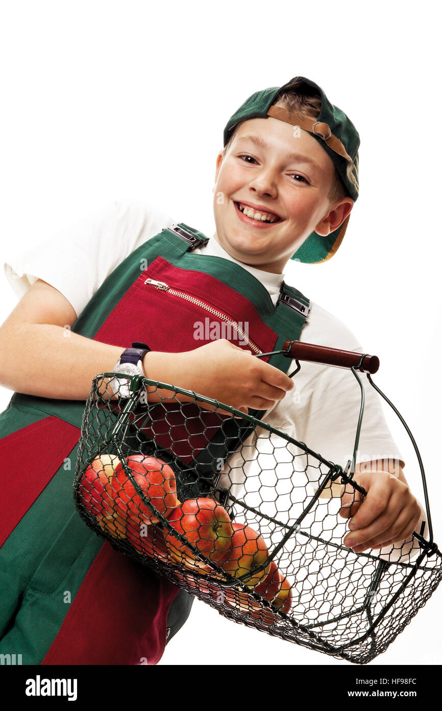 Young gardener carrying basket of fruit, wearing his hat backwards Stock Photo Alamy