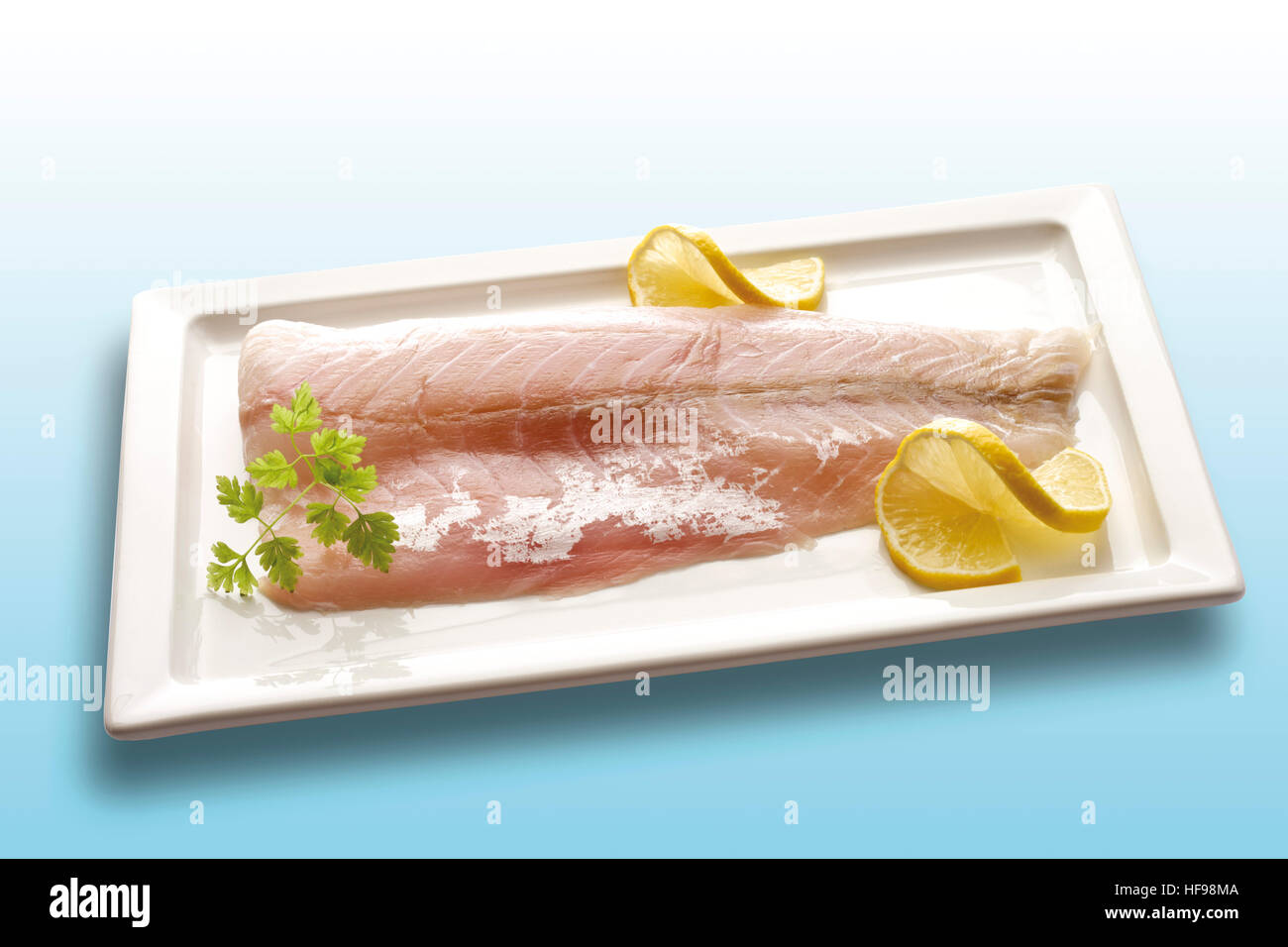 Victoria Sea Bass raw, fresh fish filets garnished with lemon slices