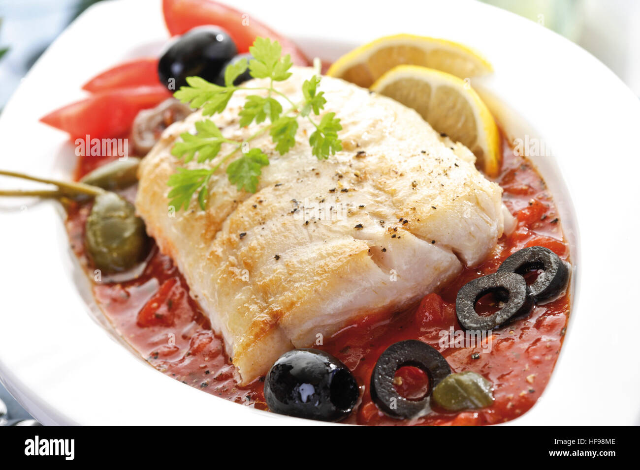 Mediterranean seafood dish fried Victoria Sea Bass with tomato sauce