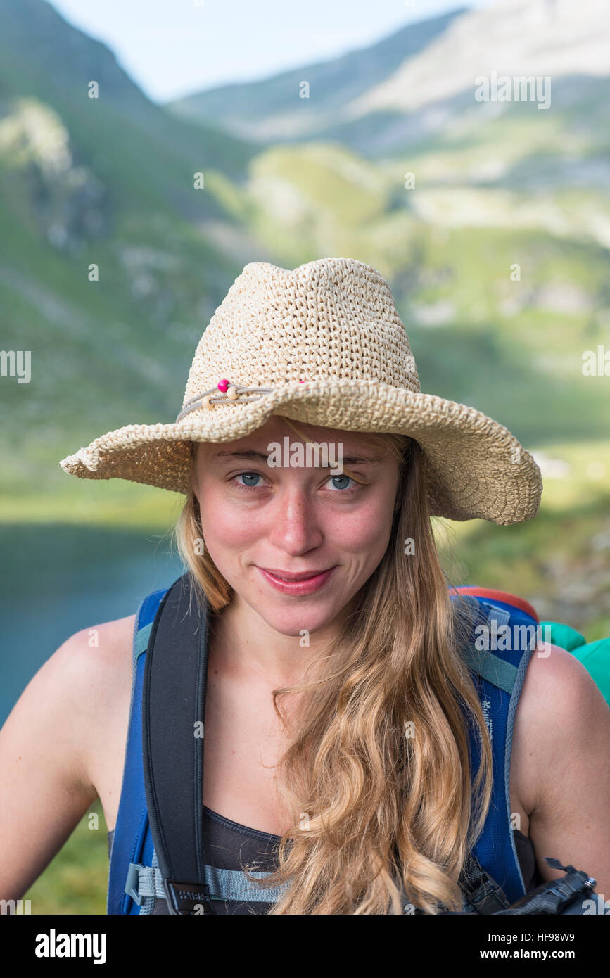 Young woman with straw hat, mountain landscape, Schladming Tauern, Styria, Austria Stock Photo