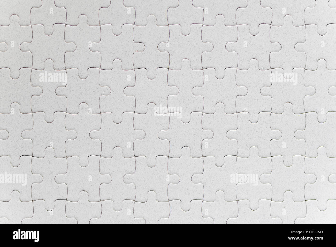Blank white jigsaw puzzle pieces completed as copy space Stock Photo