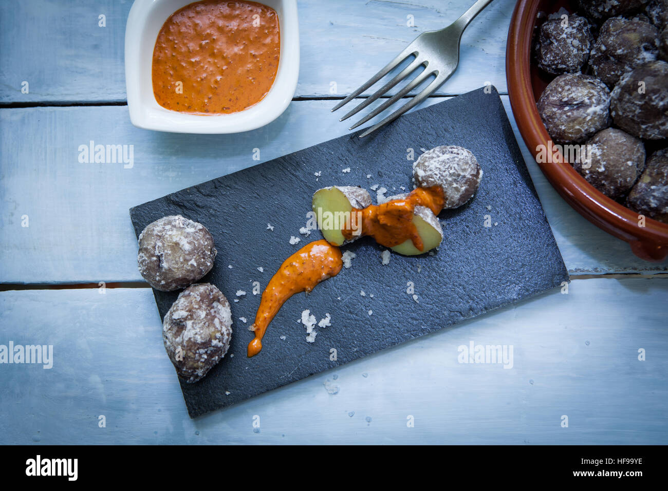 Close up of tipycal potato canaries style with red pepper sauce called mojo Stock Photo