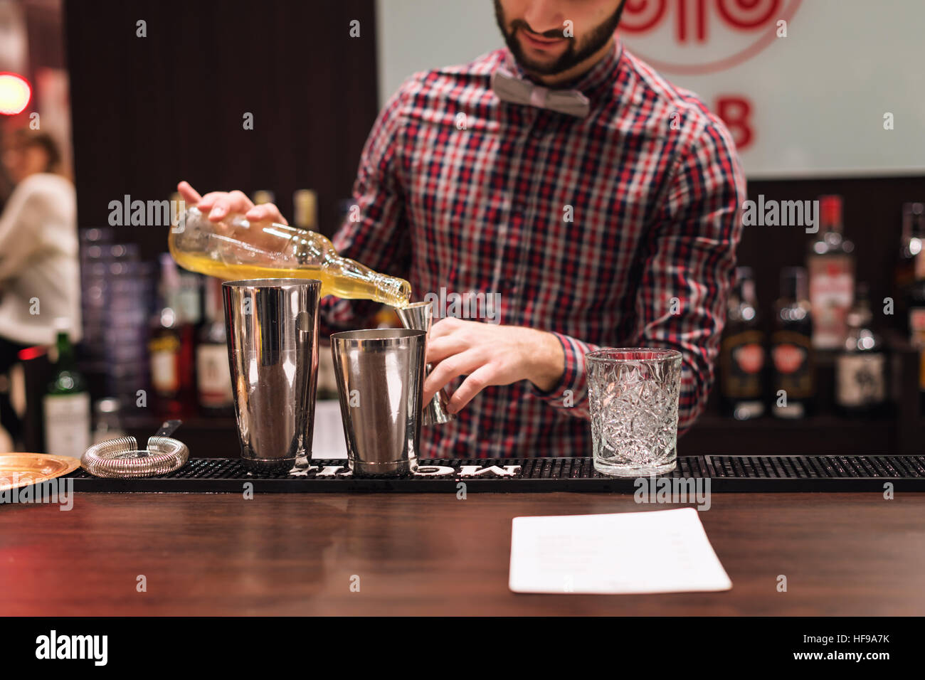 Kyiv, Ukraine - 30 october, 2016: Barman festival. Young handsome bartender is making cocktail. Stock Photo