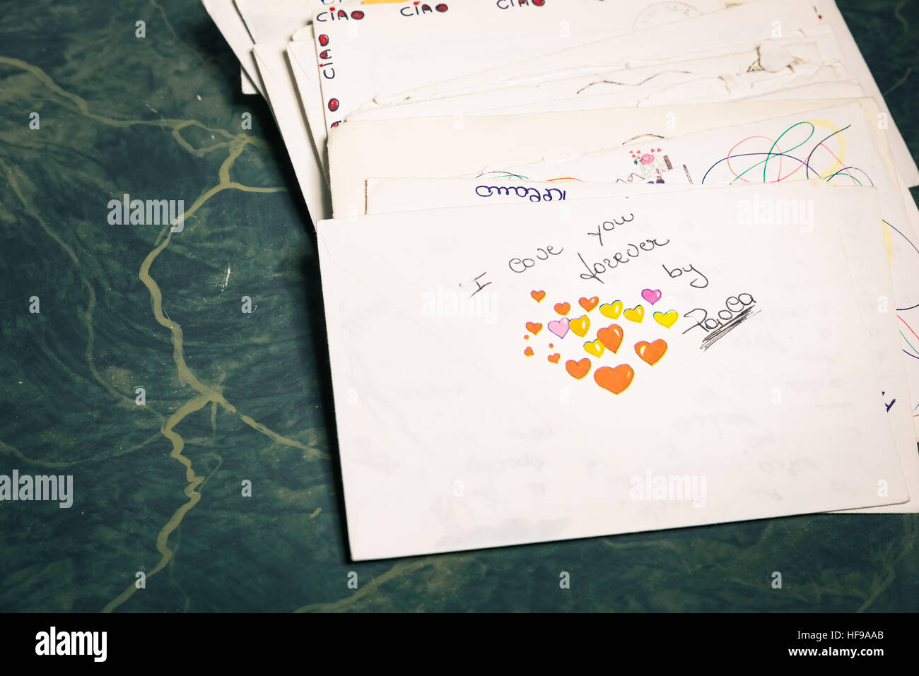 Big stack of mails, pile of papers, or heap of letters, above a letter saying 'I love you forever ...'. Stock Photo
