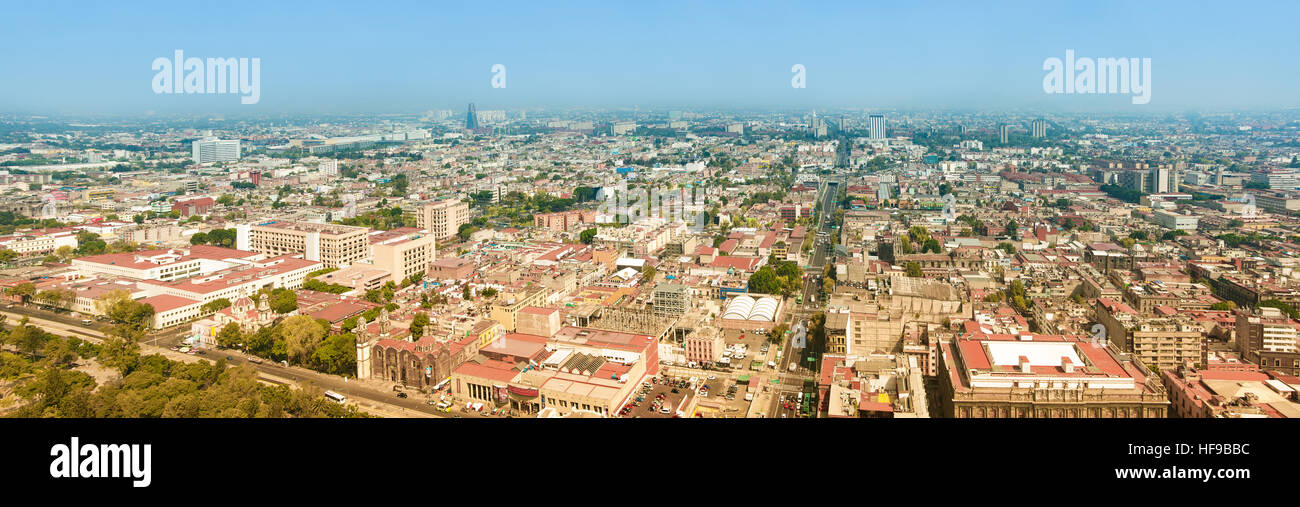 Aerial panorama of Mexico City on a sunny morning. Mexico City is a capitol on Mexico. The camera is pointed to East. Stock Photo