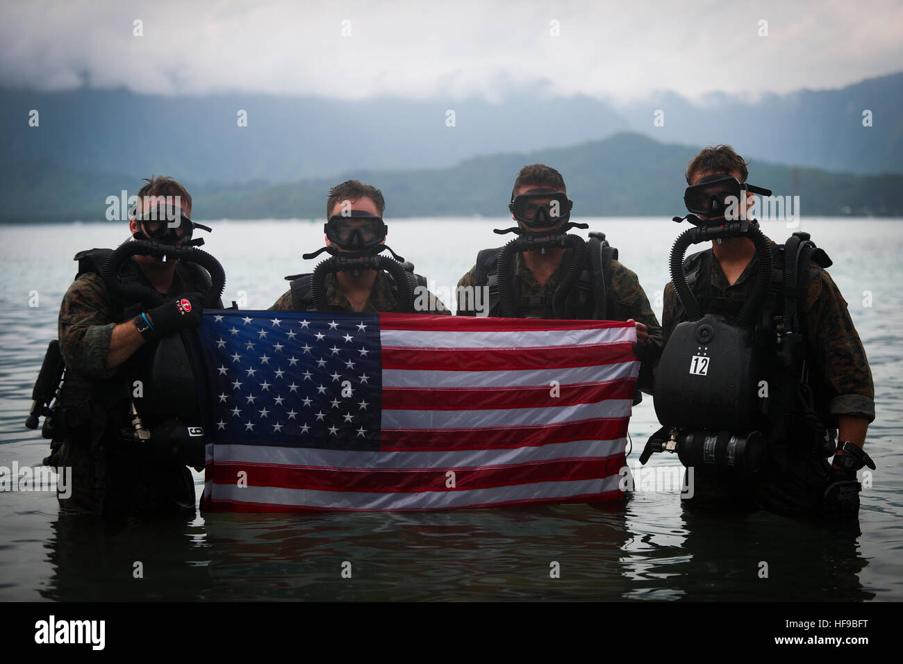 U.S. Marine Corps special operation commandos hold up the American flag