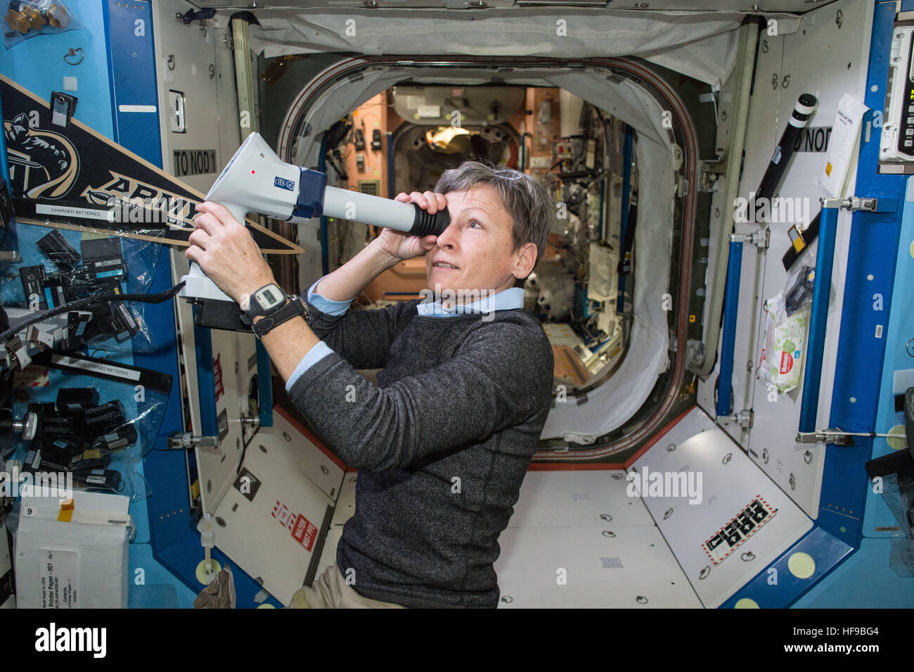 NASA Expedition 50 prime crew member American astronaut Peggy Whitson collects Fundoscope images of the back of his eye during a routine vision check aboard the International Space Station December 15, 2016 in Earth orbit. Stock Photo
