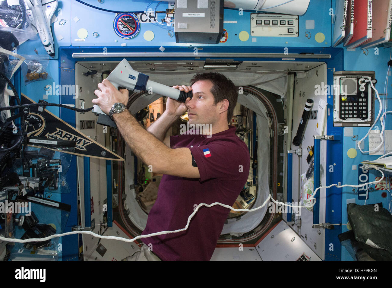 NASA Expedition 50-51 prime crew member French astronaut Thomas Pesquet of the European Space Agency collects Fundoscope images of the back of his eye during a routine vision check aboard the International Space Station December 15, 2016 in Earth orbit. Stock Photo