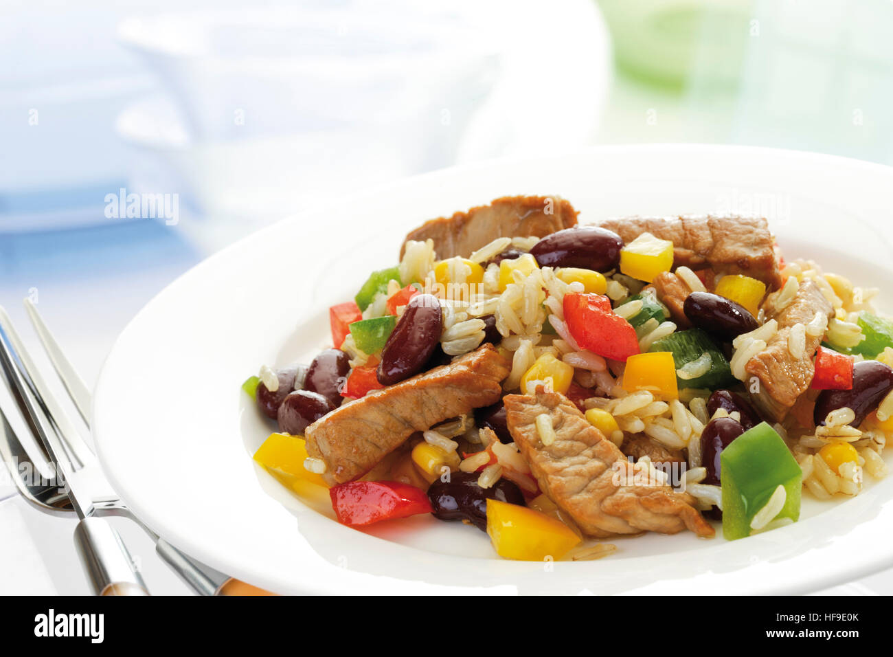 Rice dish with pork, peppers, kidney beans, corn, and longgrain rice
