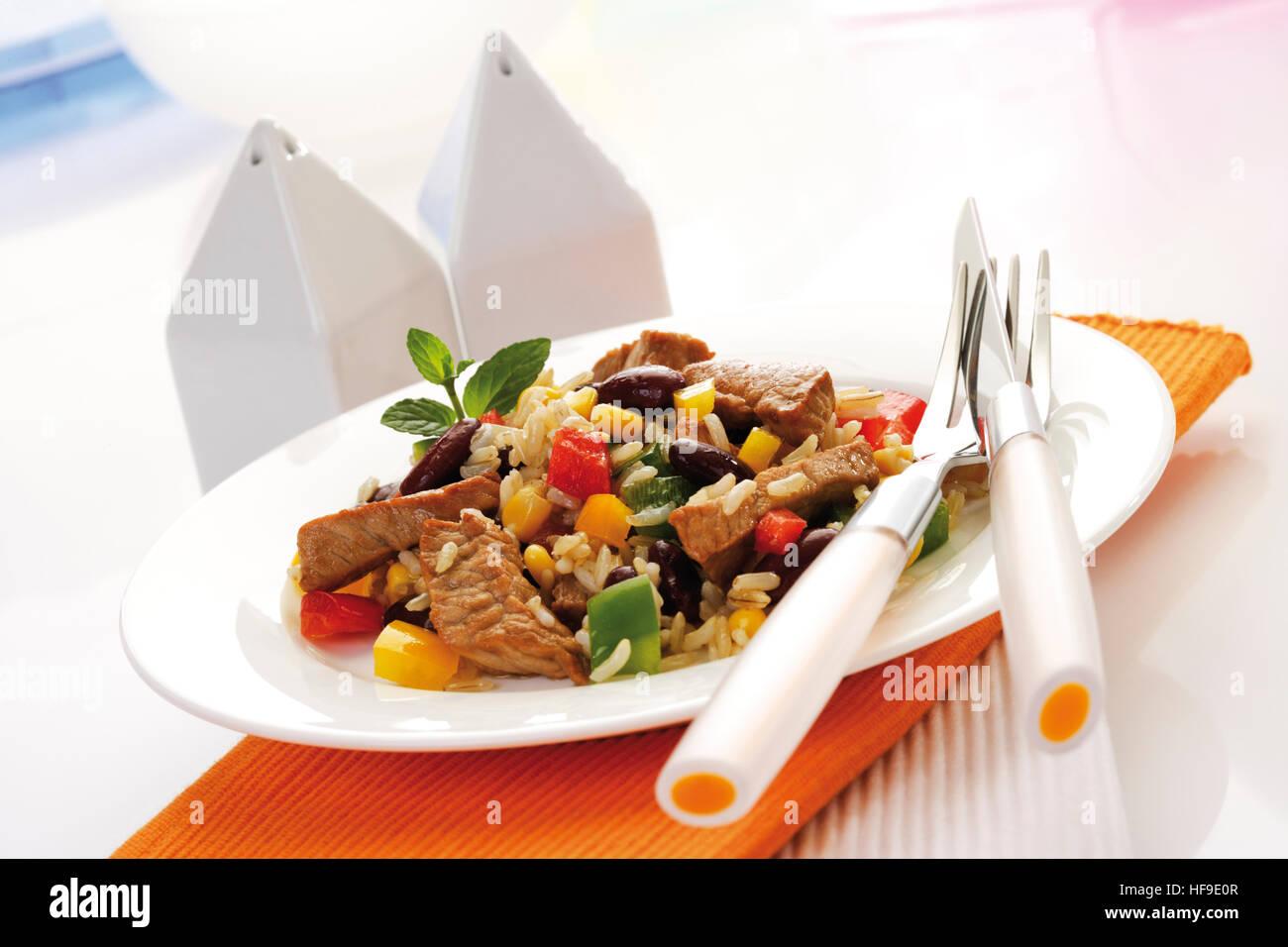 Rice dish with pork, peppers, kidney beans, corn, and longgrain rice