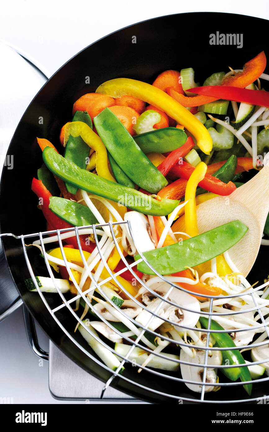 Vegetarian wok dish: button mushrooms, bell peppers, snow peas, carrots, celery, zucchini and bean sprouts Stock Photo