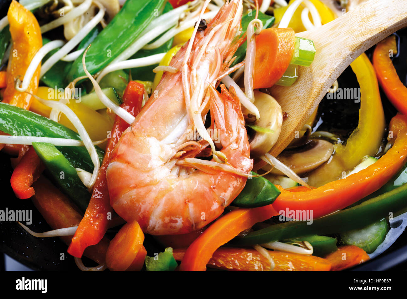 Wok dish shrimp, button mushrooms, bell peppers, snow peas, carrots, celery, zucchini and bean