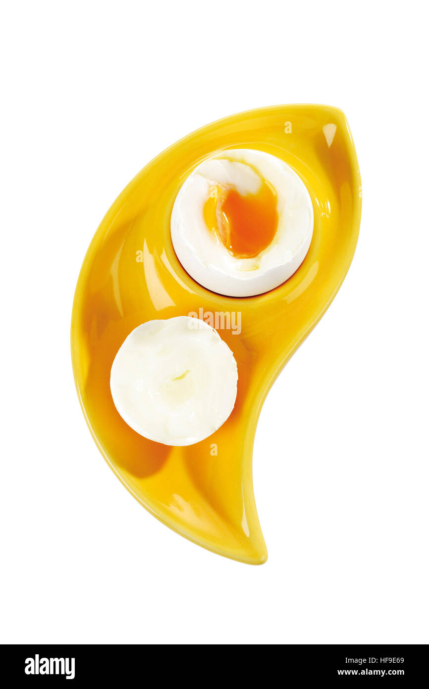 Boiled egg in a yellow eggcup Stock Photo