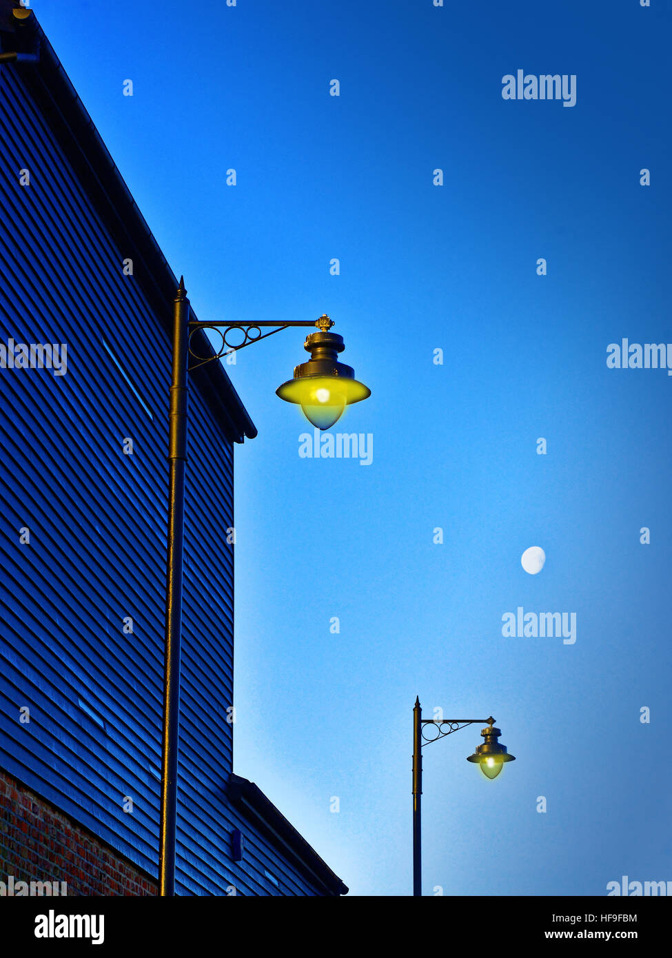Moonlit lamps deep blue sky Stock Photo