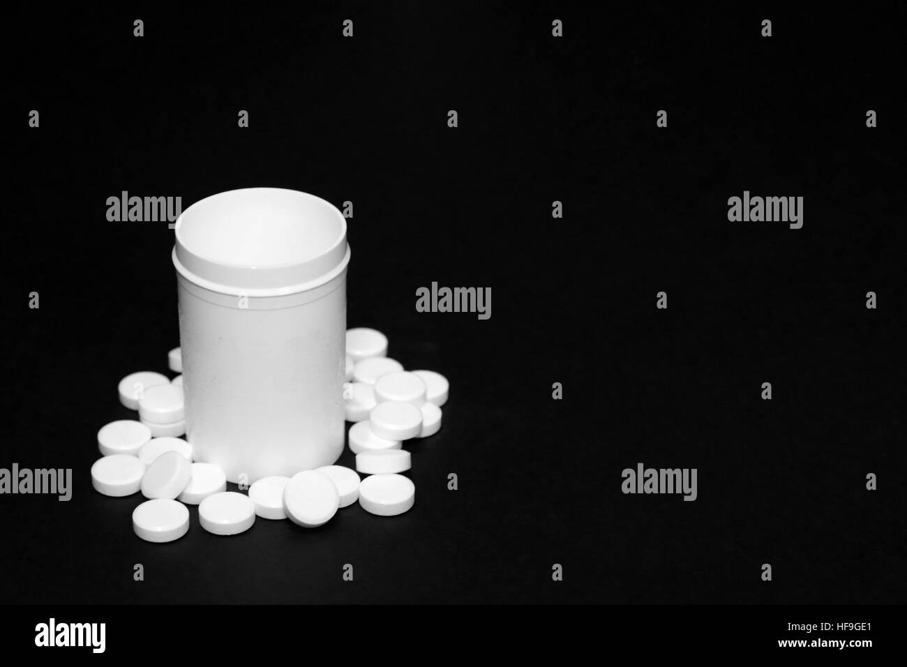 White pills, medicines painkiller. Medications on a black background