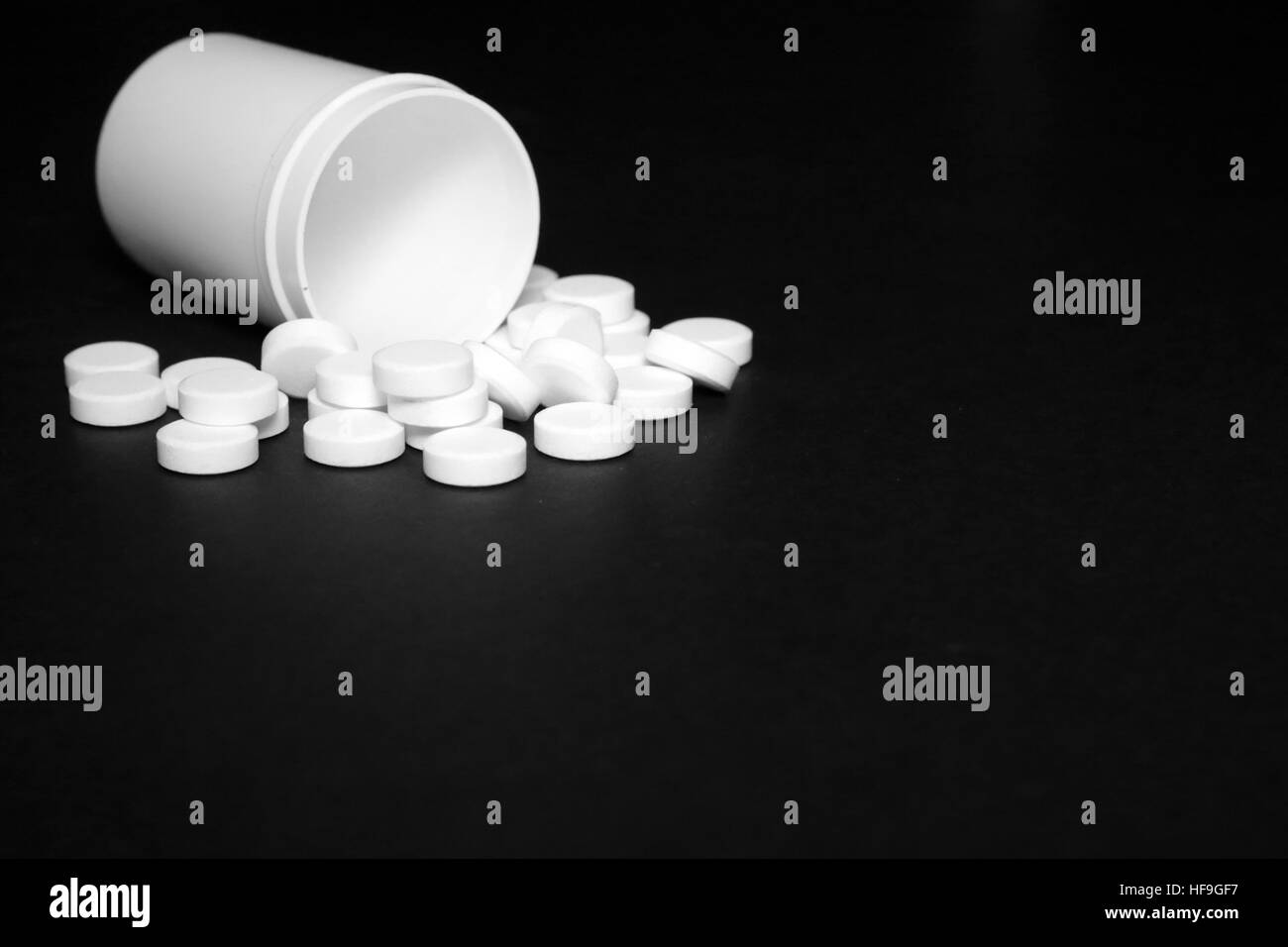 White pills, medicines painkiller. Medications on a black background