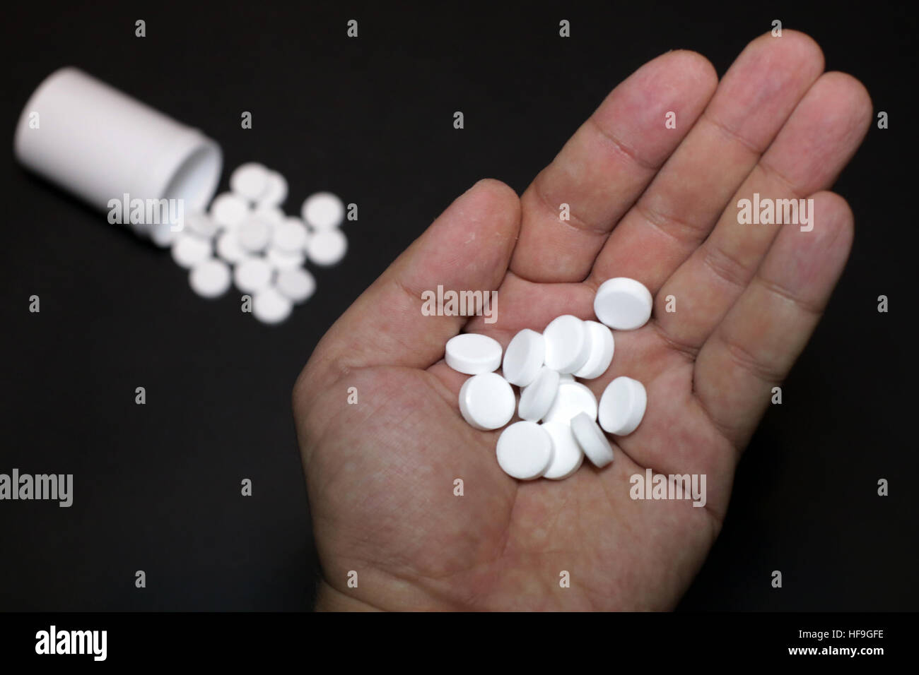 White pills, medicines painkiller. Medications on a black background
