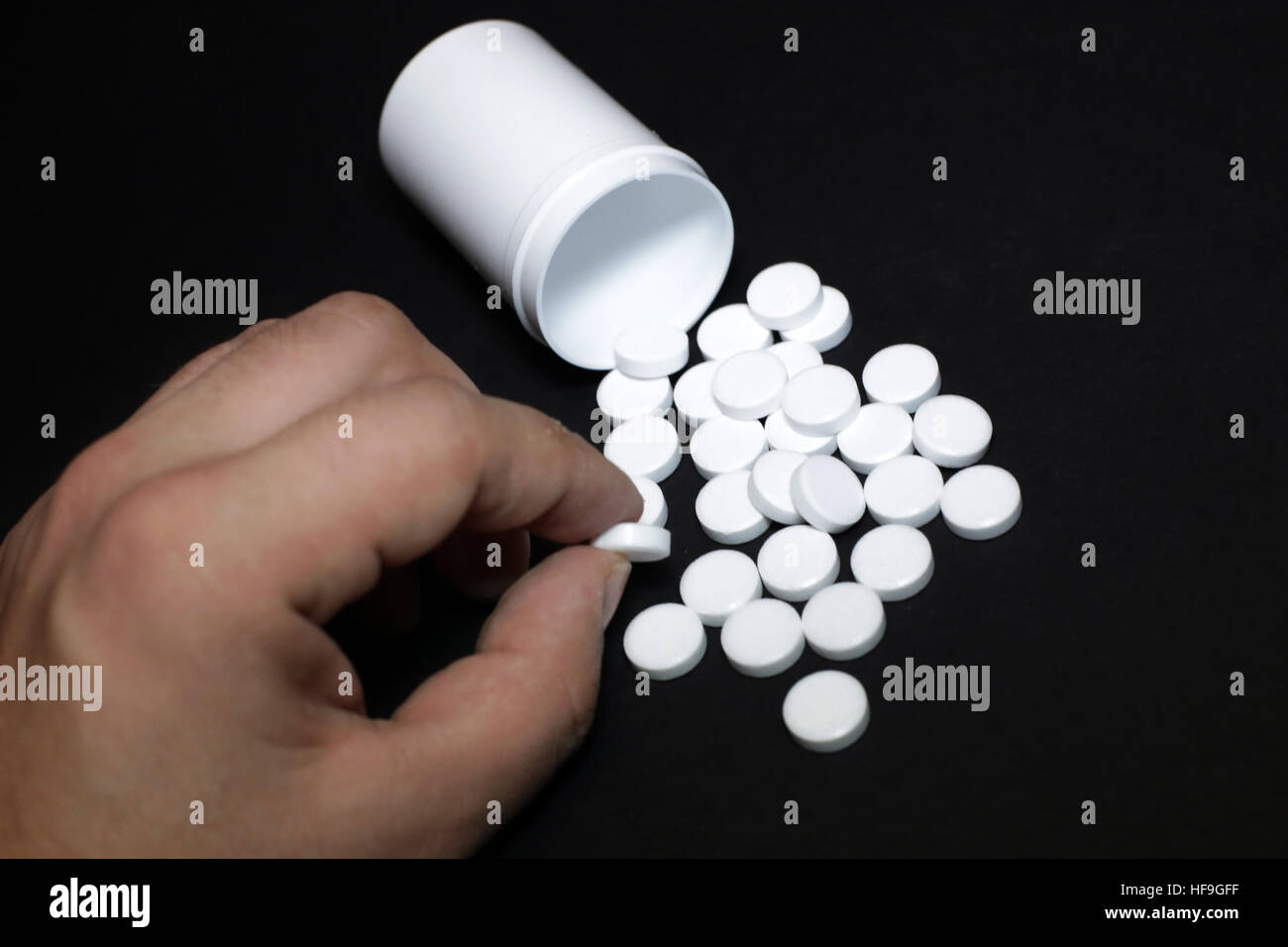 White pills, medicines painkiller. Medications on a black background