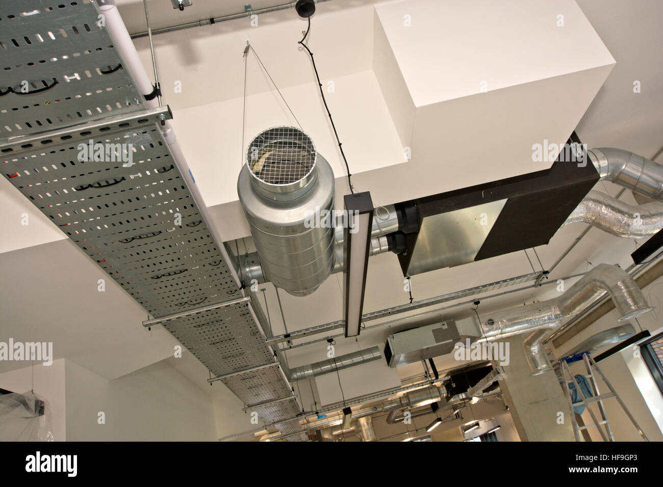 installation of air conditioning ductwork into ceiling of commercial
