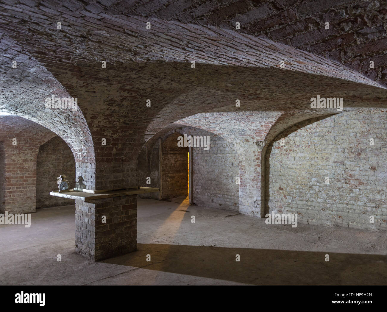 Cellar room made of brick with curved ceiling and an entrance with a