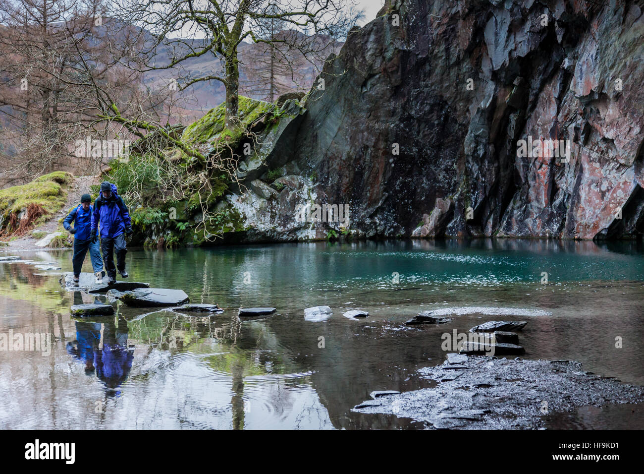 Two walkers entering Rydal Cave near Rydal Water, Rydal, Lake District, Cumbria, UK Stock Photo