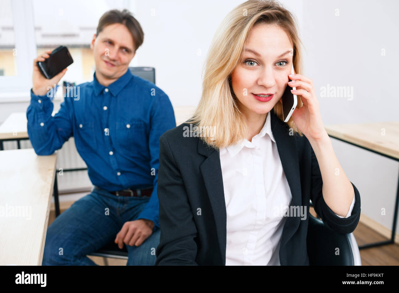 Office woman retelling gossip by phone Stock Photo