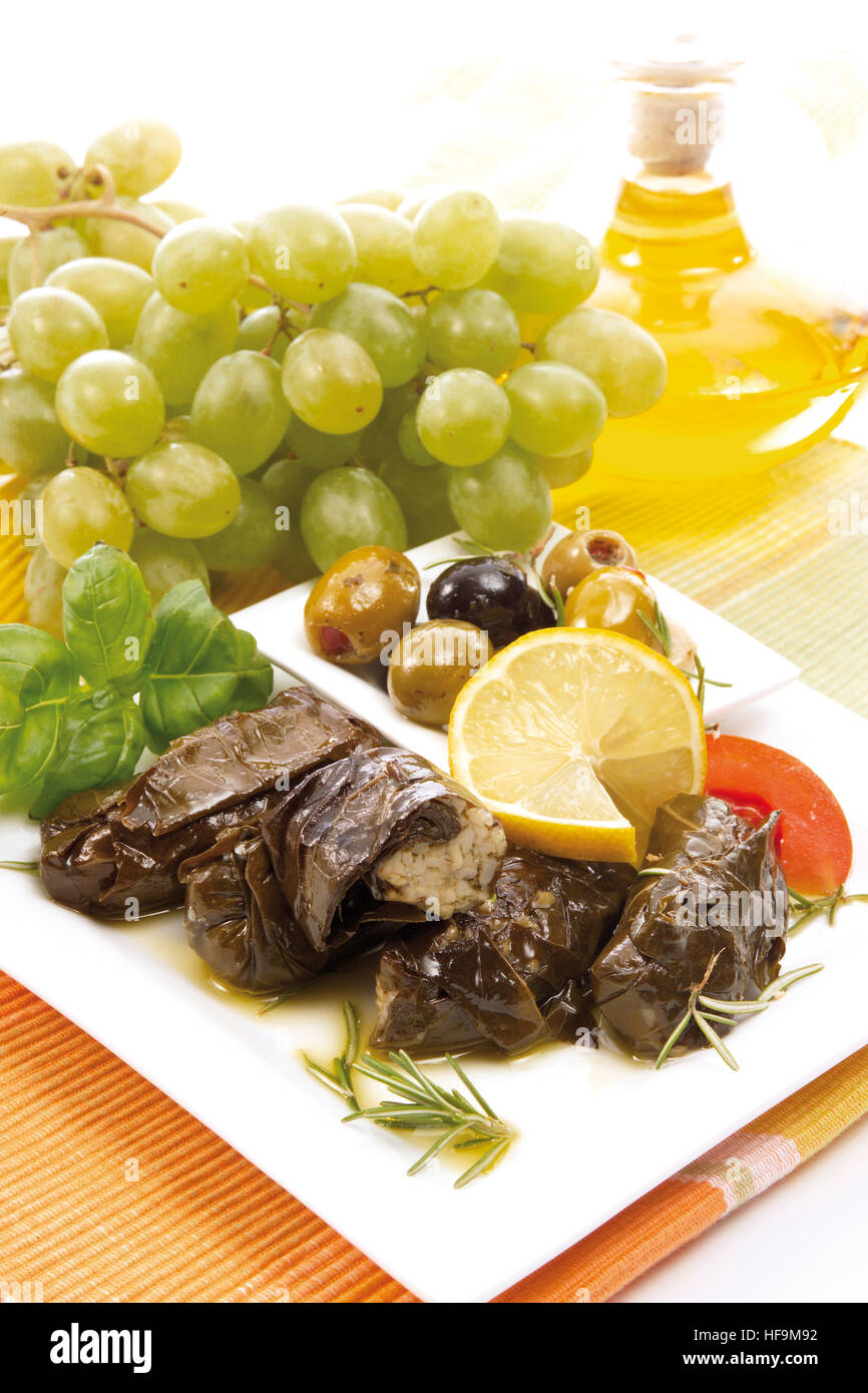 Greek specialty, vine leaves stuffed with rice (dolmades), olives, rosemary, lemon slices