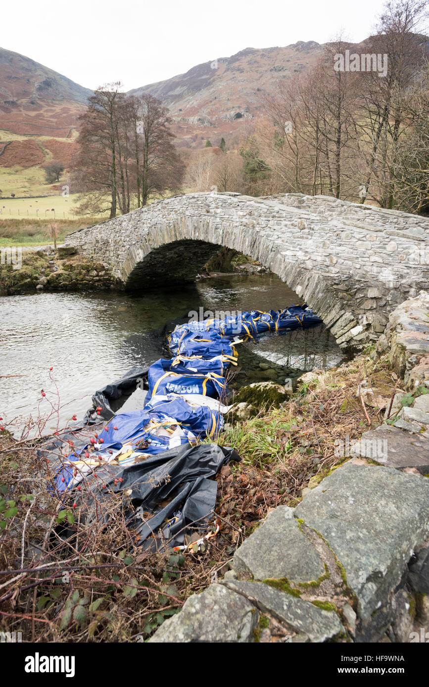 Repairs to a river bank and bridge on the River Derwent in Borrowdale the Lake District Cumbria UK Stock Photo