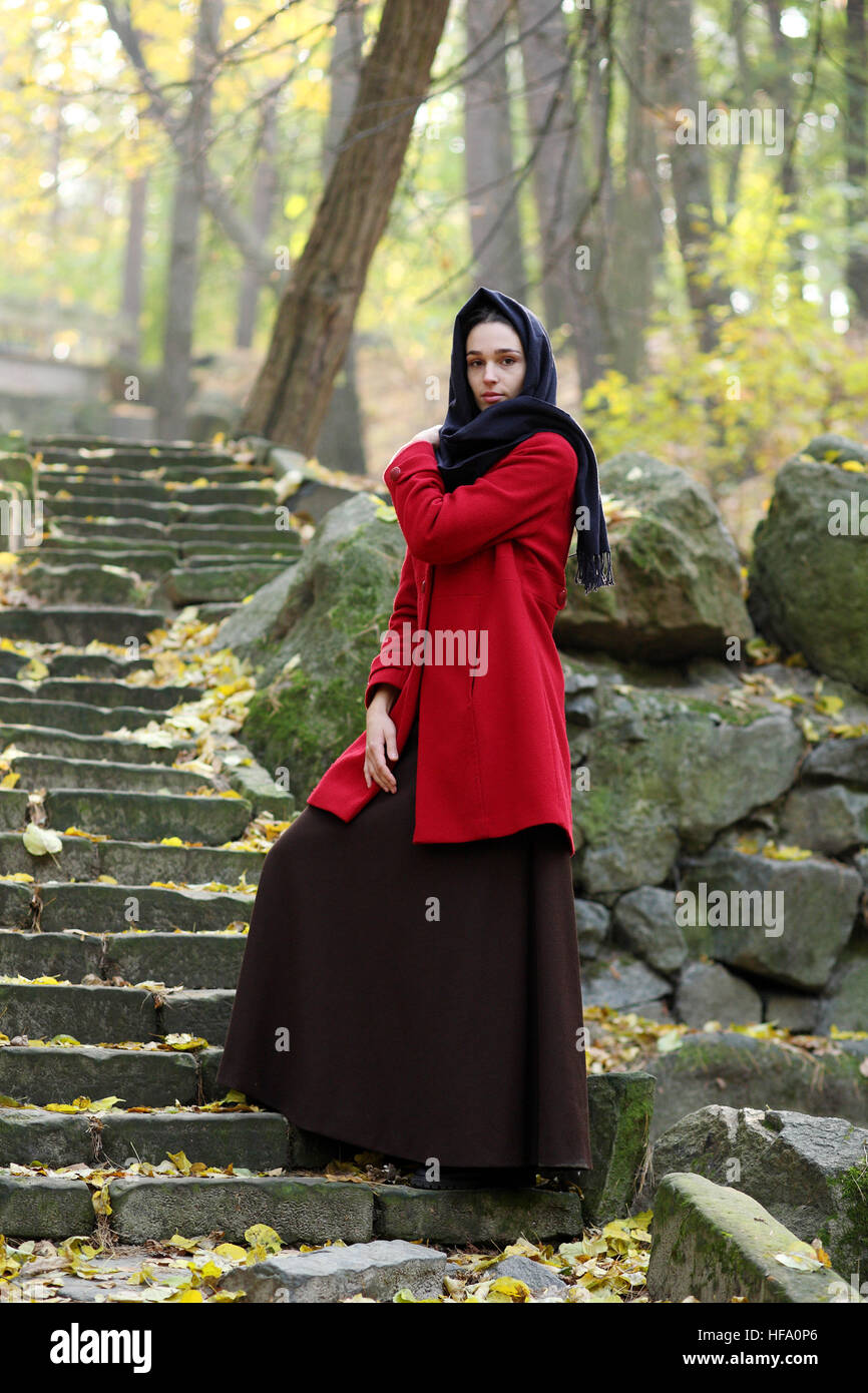 Girl in black scarf walks in autumn park Stock Photo - Alamy