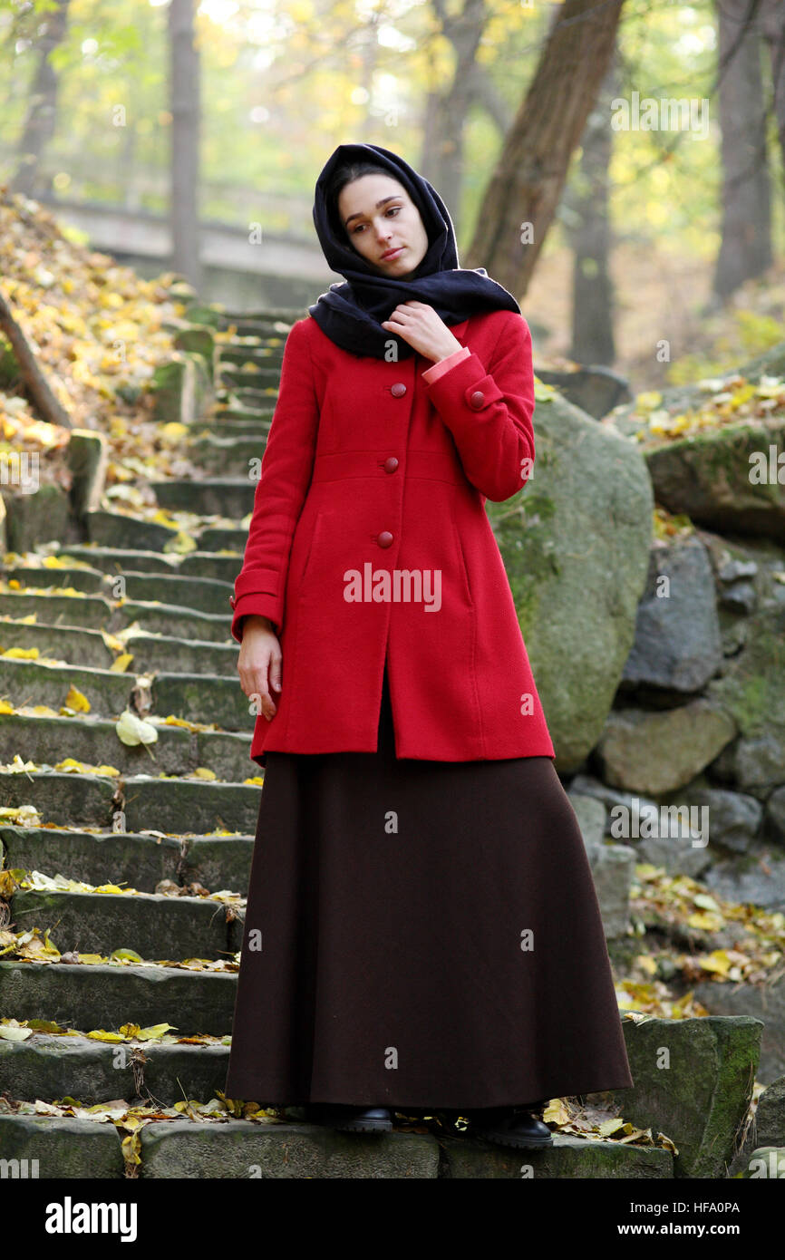 Girl in black scarf walks in autumn park Stock Photo - Alamy