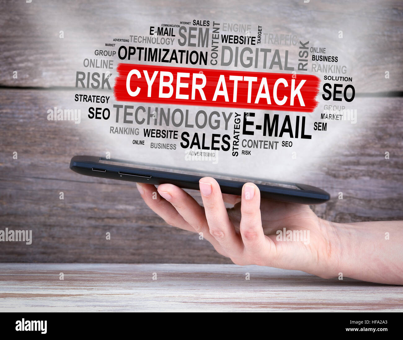 Cyber Attack concept. Tablet computer in the hand. Old wooden ...