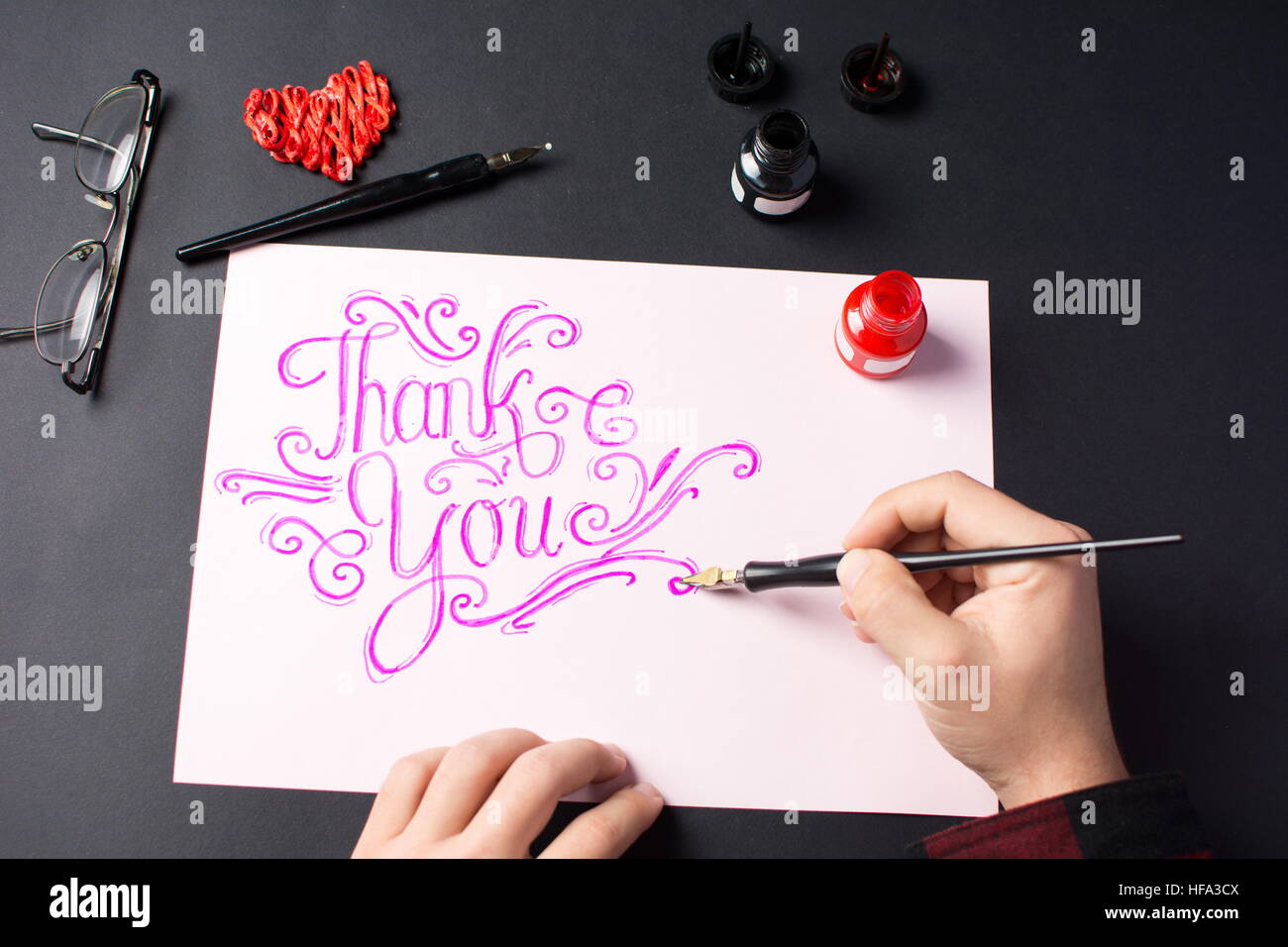 Man writing a Thank you note calligraphy Stock Photo