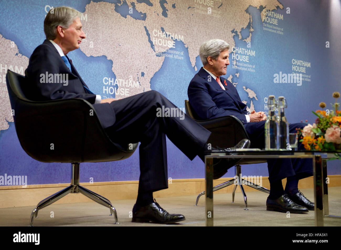 U.S. Secretary of State John Kerry listens as his former counterpart, British Chancellor of the Exchequer Philip Hammond, makes remarks before the Secretary and Iranian Foreign Minister Javad Zarif received the Chatham House Prize from the famed international think-tank in London, U.K., on October 31, 2016. Stock Photo