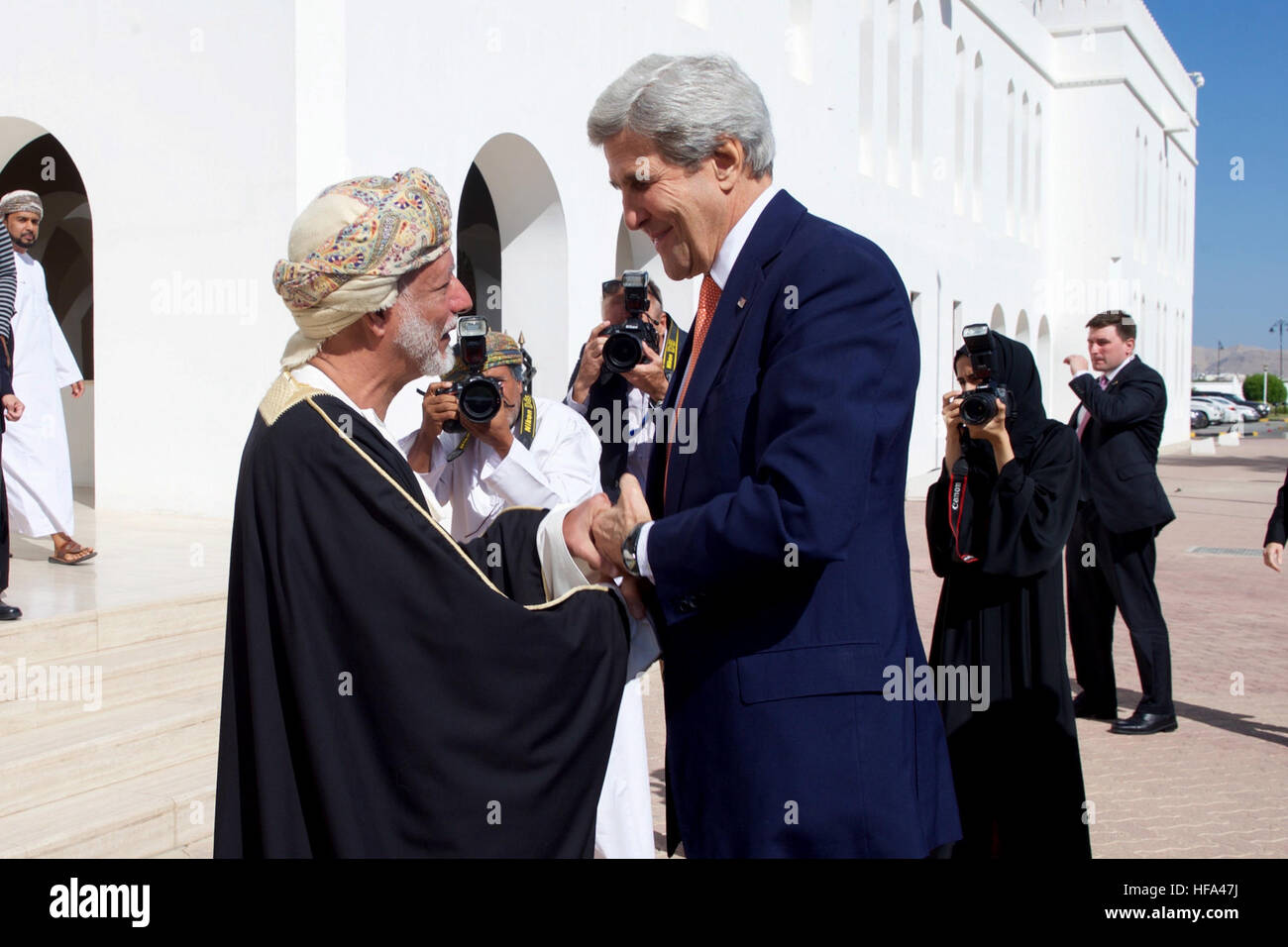 Omani Foreign Minister Yusuf bin Alawi greets U.S. Secretary of State John Kerry as he arrives at the Ministry of Foreign Affairs in Muscat, Oman, for a bilateral meeting preceding a conversation with Sultan Qaboos on November 14, 2016. Stock Photo