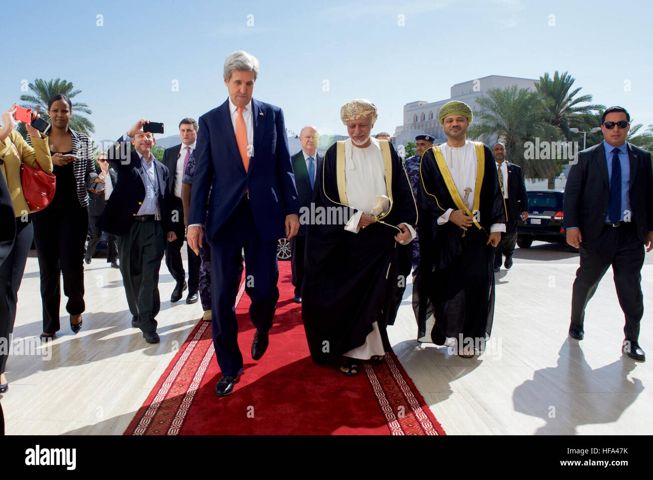 Omani Foreign Minister Yusuf bin Alawi escorts U.S. Secretary of State John Kerry as he arrives at the Ministry of Foreign Affairs in Muscat, Oman, for a bilateral meeting preceding a conversation with Sultan Qaboos on November 14, 2016. Stock Photo