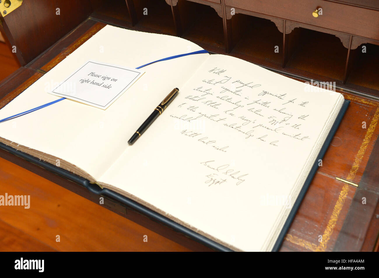 Egyptian Foreign Minister Sameh Shoukry signs U.S. Secretary of State John Kerry's guestbook before their meeting and signing of the U.S.-Egypt cultural property agreement, at the U.S. Department of State in Washington, D.C., on November 30, 2016. Stock Photo