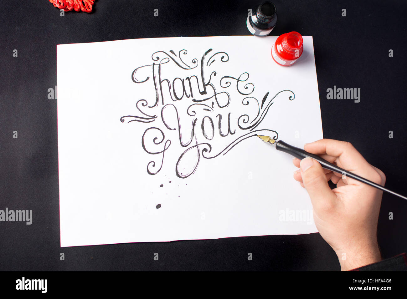 Man writing a Thank you note calligraphy Stock Photo