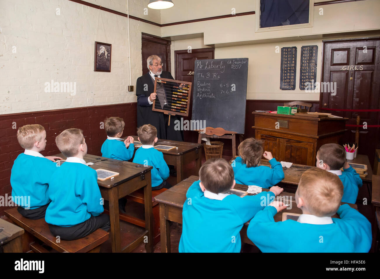 A recreation of a Victorian Classroom. A teacher with an abacus teaching maths to current Primary School children. Stock Photo