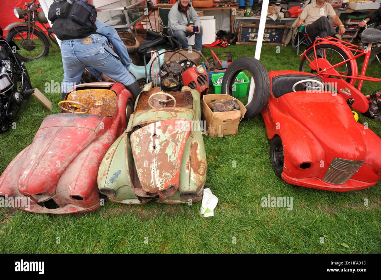 Classic car owners look through stalls of rare parts and automobilia at Beaulieu Autojumble - Austin J40 pedal cars Stock Photo