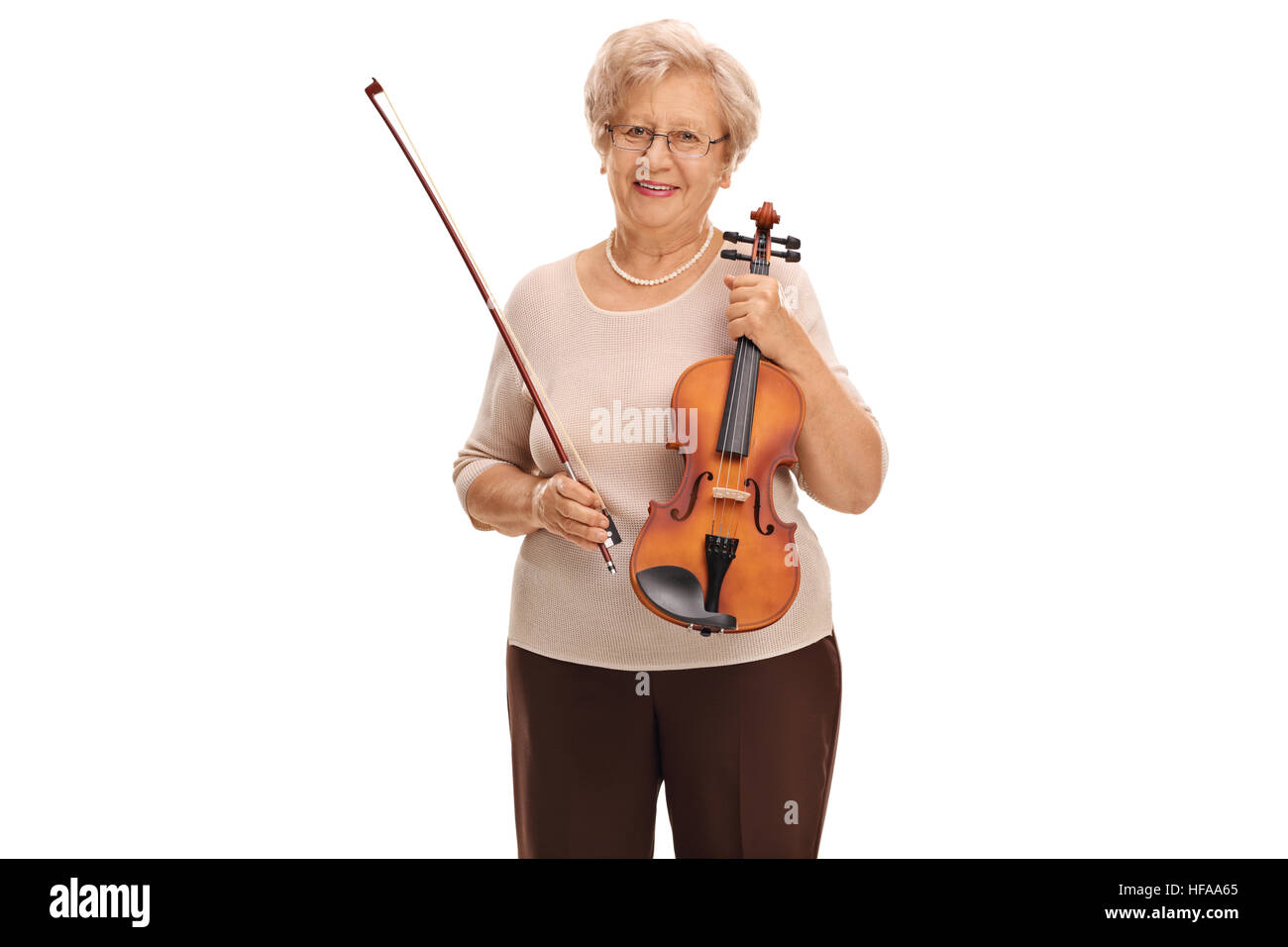 Elderly woman holding a violin and a bow isolated on white background Stock Photo
