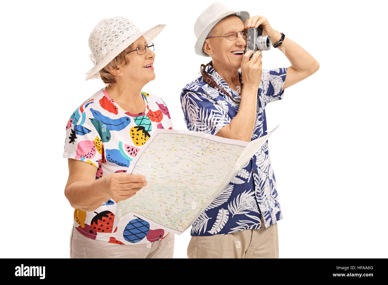 Mature female tourist holding a generic map with a mature male tourist taking a picture with a camera isolated on white background Stock Photo
