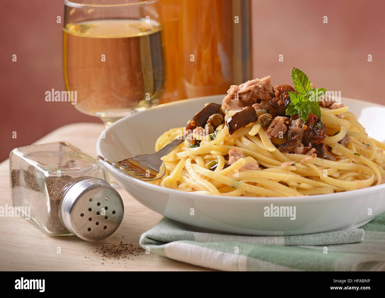 Spaghetti with tuna, capers and eggplant Traditional Italian recipe Stock Photo Alamy