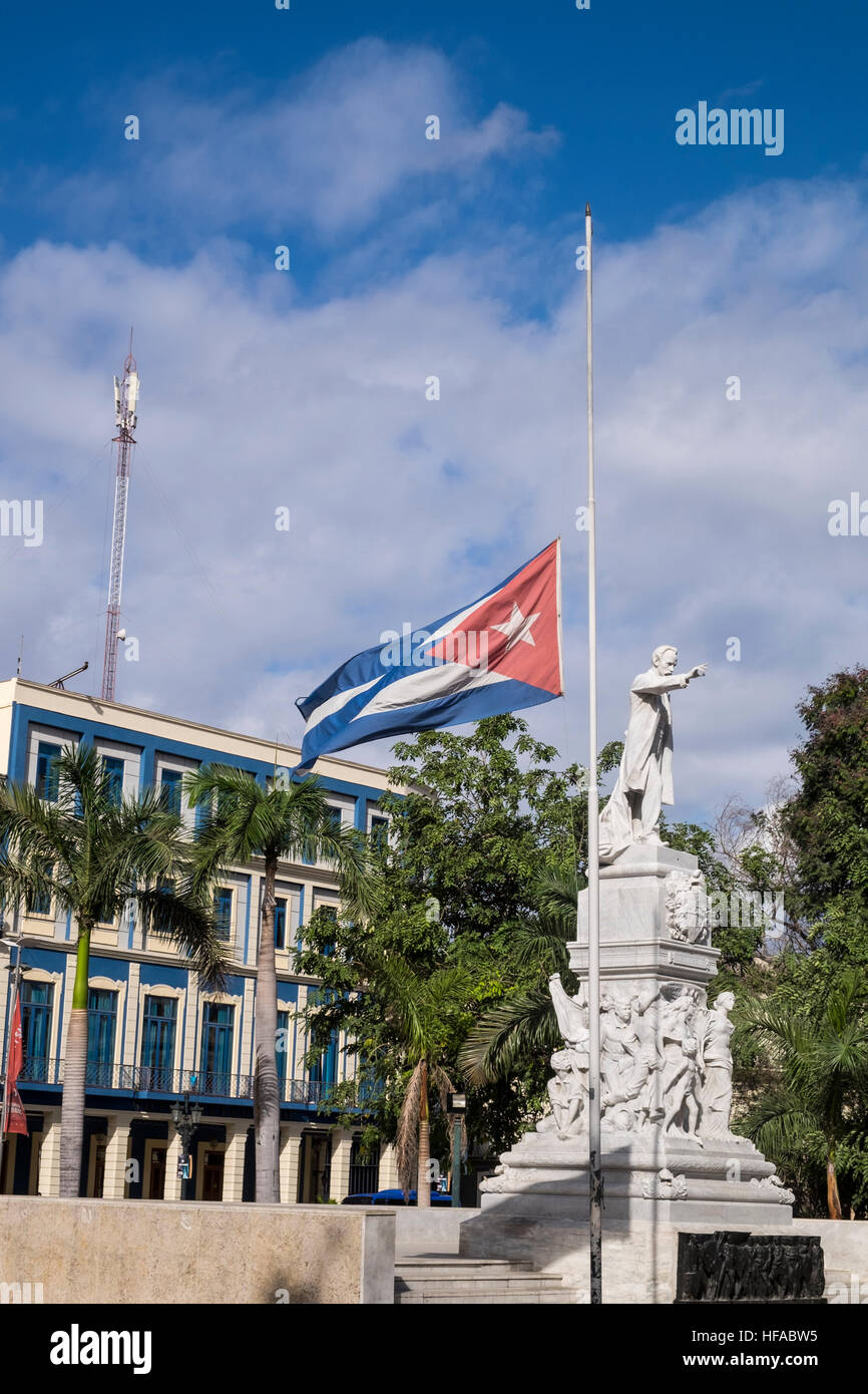 Flag at half mast with statue of Jose Marti on the day Fidel Castros death was announced, Parque Central, La Havana, Cuba. Stock Photo