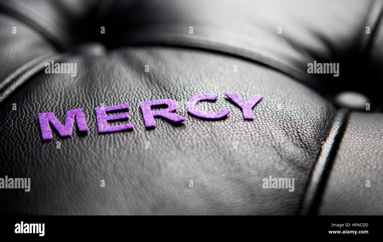 the word Mercy in purple on black leather Stock Photo