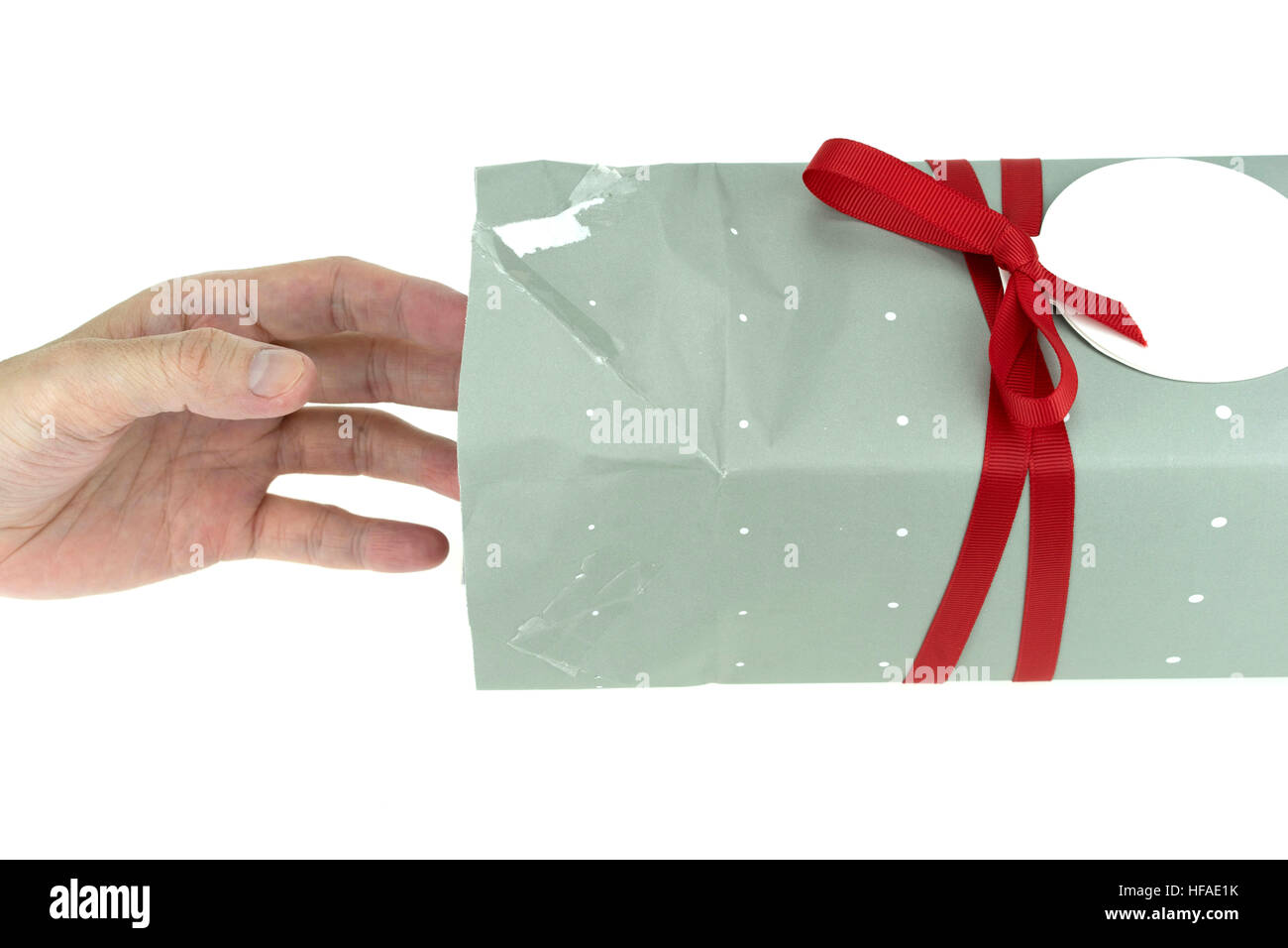 Hand reaching into a gift box, clipping path included, isolated on white background Stock Photo