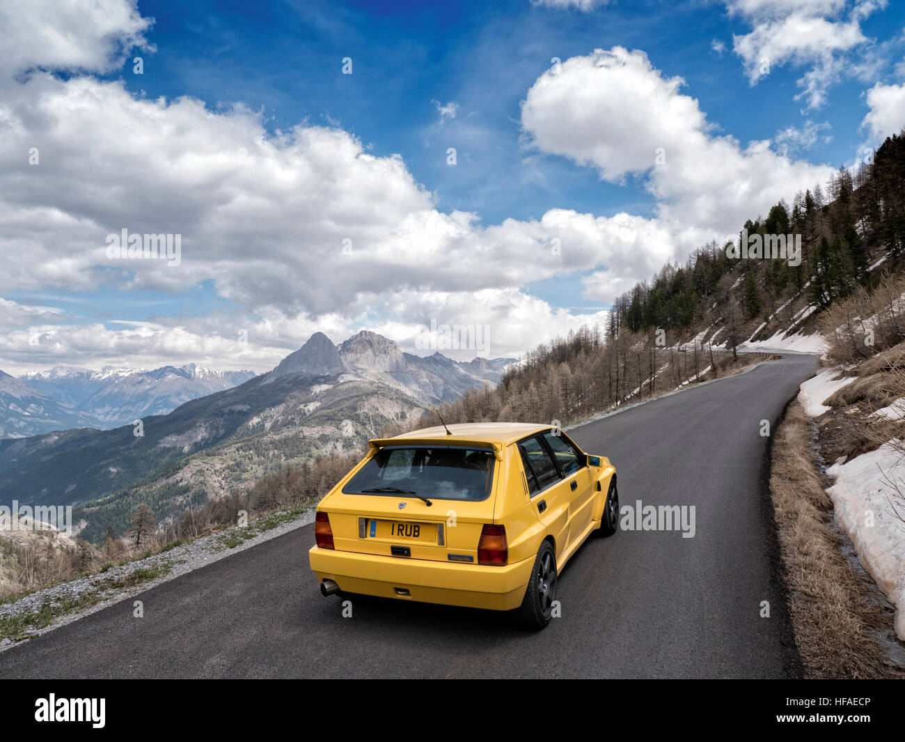 1995 Lancia Delta HF Integrale driving on roads in the French alps Stock Photo