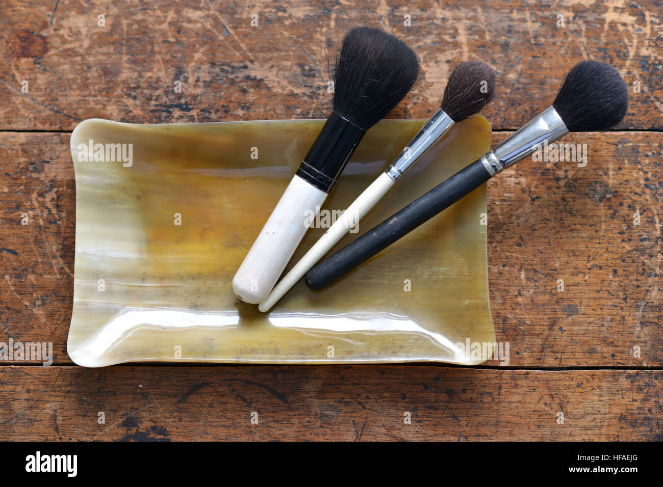 Makeup brushes in a horn container, luxury bathroom Stock Photo
