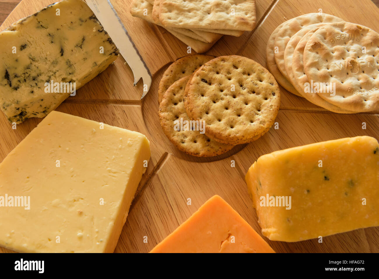 Assortment of cheeses on a round wooden cheese board Stock Photo Alamy