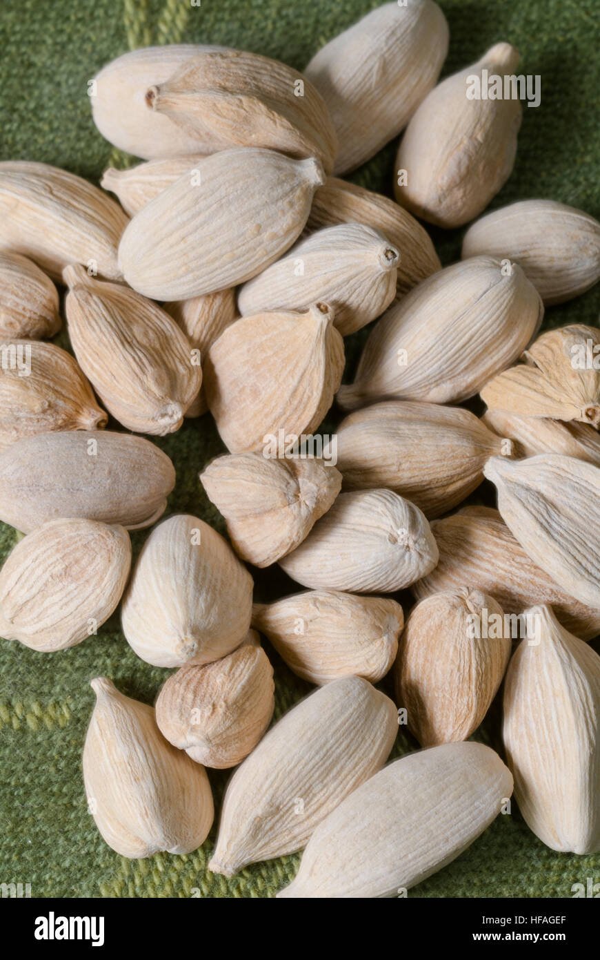 Cardamom seed pods Ellettaria cardamomum spice, dried harvested in pile closeup macro image food Asian Indian Thai cuisine Stock Photo