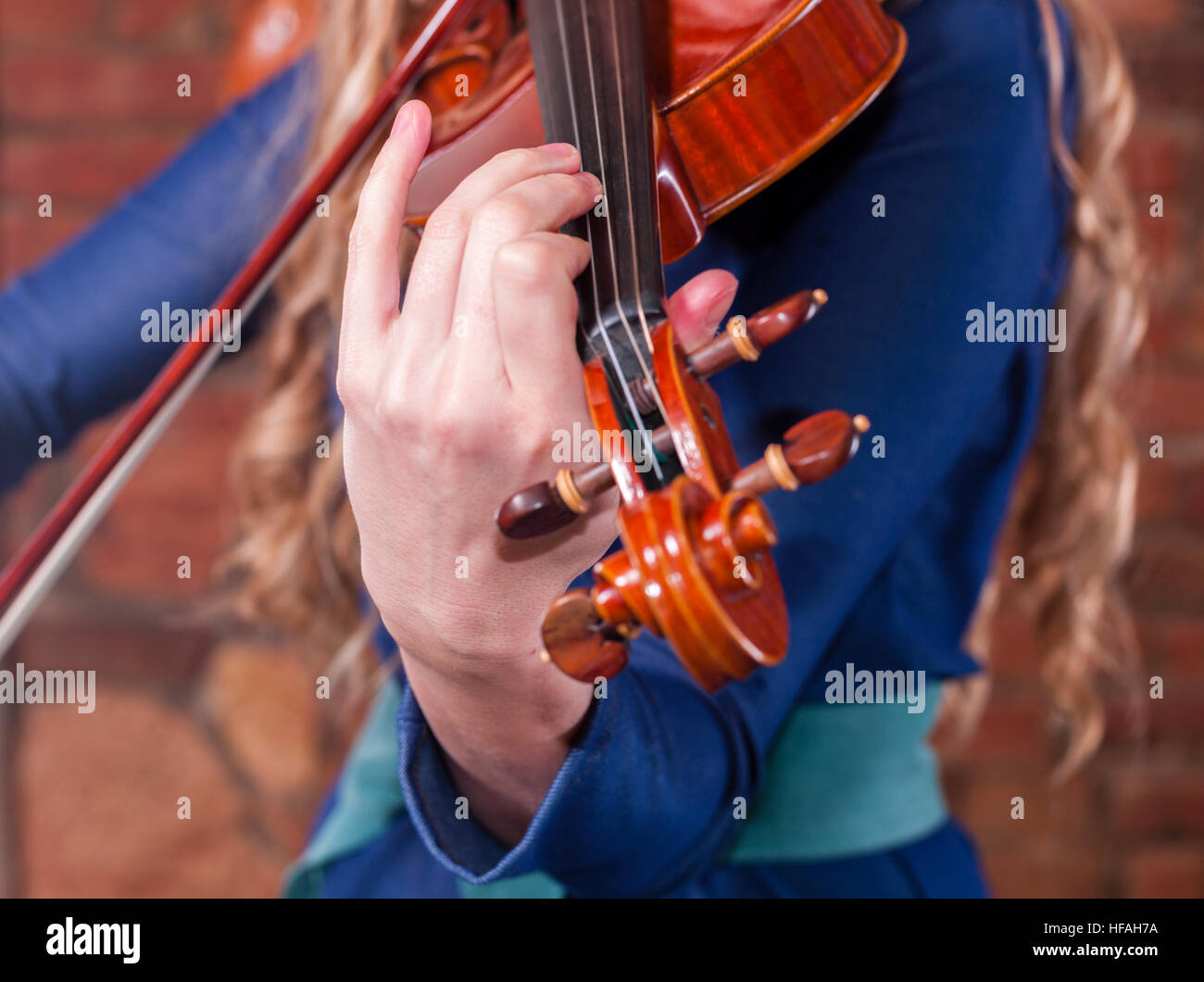 A woman playing music on a violin Stock Photo